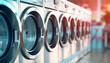 A row of white washers and dryers are lined up in a laundry room