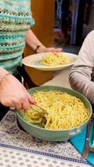 Wall Mural - A woman is serving pasta to a man.