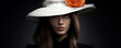 Girl face with black hat against black background.