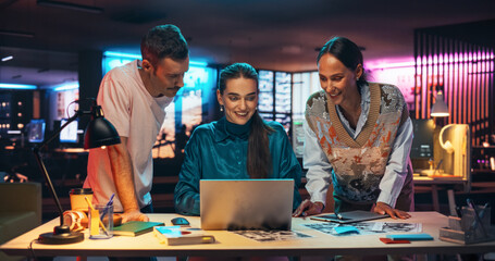Poster - Group of Young Successful Businesspeople Making a Team Meeting in Creative Agency Using Laptop Computer. Excited Diverse Team Discussing a New Digital Marketing Plan in a Creative Office