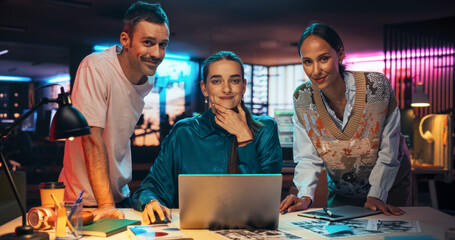 Poster - Posing Shot of a Diverse Group of Talented Young Business People Gathered Around a Desk in a Modern Creative Office, Brainstorming. Multiethnic Teammates Looking at Camera and Smiling