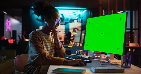 Fototapete - Portrait of Black Female Working in Creative Agency, Implementing Modern Business Strategy for Clients. Successful Specialist Using Desktop Computer with Green Screen Mock Up Display
