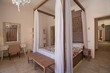 Interior design of bedroom in house with four poster bed