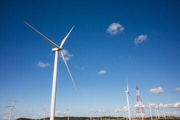 wind turbine in the field with blue sky background