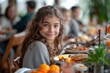 Young Girl Sitting at Table With Plates of Food