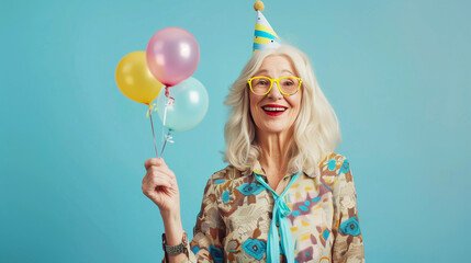 Wall Mural - senior wrinkled woman, celebrates birthday wears festive clothes isolated over pink background