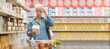 © StockPhotoPro - Senior woman with vision problems reading information on a product package at the supermarket