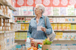 © StockPhotoPro - Senior lady buying groceries at the store