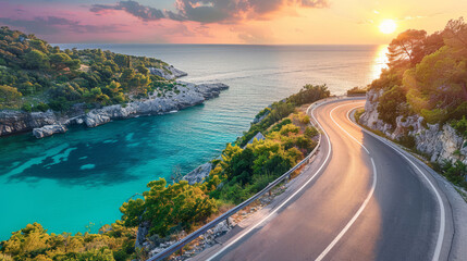 Wall Mural - Scenic coastal road winding along turquoise water at sunset