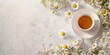 © Lars - Chamomile blossoms and tea on white surface with space for text