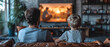 Father and son watching television at home. Leisure and entertainment concept