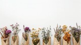 Fototapeta Kuchnia - A row of dried flower bouquets wrapped in kraft paper on a white background