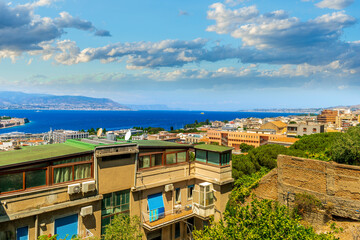 Wall Mural - panoramic summer travel view from a hill to  beautiful sea coast historical town with port, amazing ocean bay and gulf and beautiful mountains with scenic sunset on background.