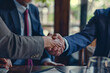 businessman shaking hands between friends in a meeting
