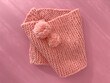 Soft pink lace knitted round scarf isolated on pastel pink background. Fashion children's accessory.