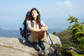 Wall Mural - girl tourist on the background of a mountain landscape