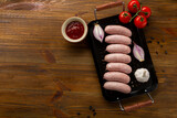 Fototapeta Tulipany - top view of raw  sausages for grill bbq