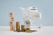 © Ratana21 - For buy now pay later , online shopping concept, wooden cube block with BNPL text and stack of coins, blurred white calculator in shopping cart and clock