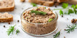 dry liver pate, in glassware with little toasts and olive oil rosemary on a light background