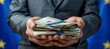 © Ilja - Businessman s hands holding euro bills with eu flag in background, space for text