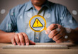 .Businessman using computer searching social media and magnifying glass triangle caution warning sign for notification error, maintenance, warning and safety concept