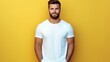 Young man in white t-shirt on yellow background. Mockup of t-shirt.