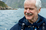 Fototapeta Dmuchawce - Happy senior enjoying retirement in the nature on a boat.