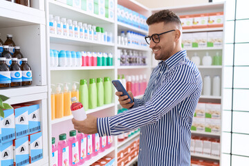 Poster - Young hispanic man customer make photo by smartphone to medicine bottle at pharmacy