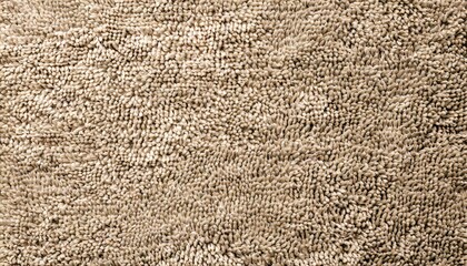 carpet floor mat or beach towel texture background in sepia beige color made of wool or synthetic fibers polypropylene nylon or polyester material