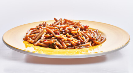 Poster - A sumptuous plate of pasta covered in tomato sauce served on a yellow dish against a white background.