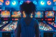 A young woman in an arcade saloon in frond of pinball machines.