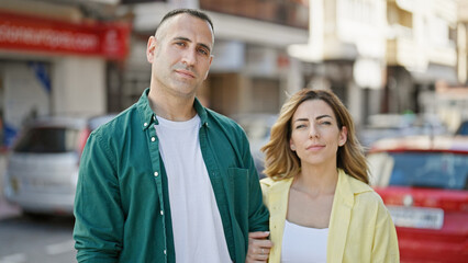 Poster - Man and woman couple smiling confident standing together at street