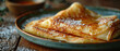 Folded pancakes with sugar powder on the plate on the wooden table. Horizontal banner 7:3