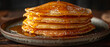 Thick pancakes with golden syrup pouring and bubbling from above. Horizontal banner 7:3