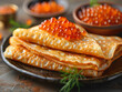 Folded pancakes with red caviar and bowl of caviar. Horizontal banner 7:3.