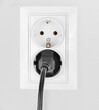 © Илья Подопригоров - Power electric sockets on a white wall. electric cord plugged into a white electricity rosette on white background. outlet on the white wall