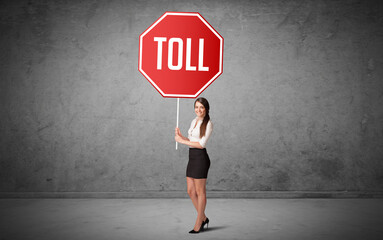 Wall Mural - Young business person holding road sign