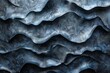 Abstract cool blue-toned image of wavy metallic surface depicting calmness and a fluid motion effect