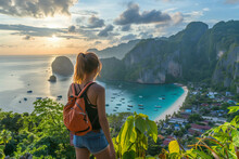 A Woman Standing At Phi Phi View Point And See The View From A Bird's Eye View Of The Mountains, The Sea And The Sunset. And Town On Phi Phi Island, Krabi Province, Thailand (2)