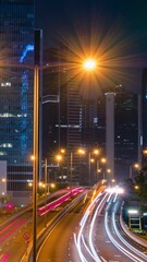 Wall Mural - Street traffic in Hong Kong at night timelapse. Office skyscraper buildings and busy traffic on highway road with blurred cars light trails. Hong Kong, China