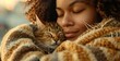Woman in a cozy sweater Embracing her sleeping cat