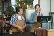 © Ekkasit A Siam - The beautiful Asian daughter of the cafe owner Receiving call from the phone to receive orders Retired single mother receives pension grinding coffee beans and turned head to look  daughter and smiled