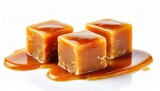 Fototapeta Tulipany - Three sweet caramel candy cubes topped with caramel sauce isolated on white background 