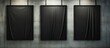Three rectangular black canvases with various tints and shades are displayed on a grey concrete wall, creating a monochrome pattern