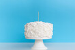 © Gravity Digital - Cake topper mock up . Styled with against a blue background. Close up birthday , wedding cake topper mockup