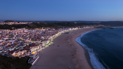 Sunset in Praia da Vila Nazaré, the busiest beach on the west coast and one of the most traditional fishing villages in Portugal         