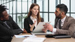 © Katsiaryna - Three business people in the office working together.