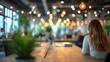 © Ekaterina - coworker, Woman sitting alone in office space with blurred people and bokeh lights in the background. Casual workplace concept with place for text. Design for banner, poster, header