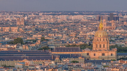 Wall Mural - Aerial view of a large city skyline at sunset timelapse. Top view from the Eiffel tower. Paris, France.