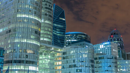 Wall Mural - Paris cityscape with modern buildings in business district timelapse by night. Glass facade skyscrapers. Paris, France